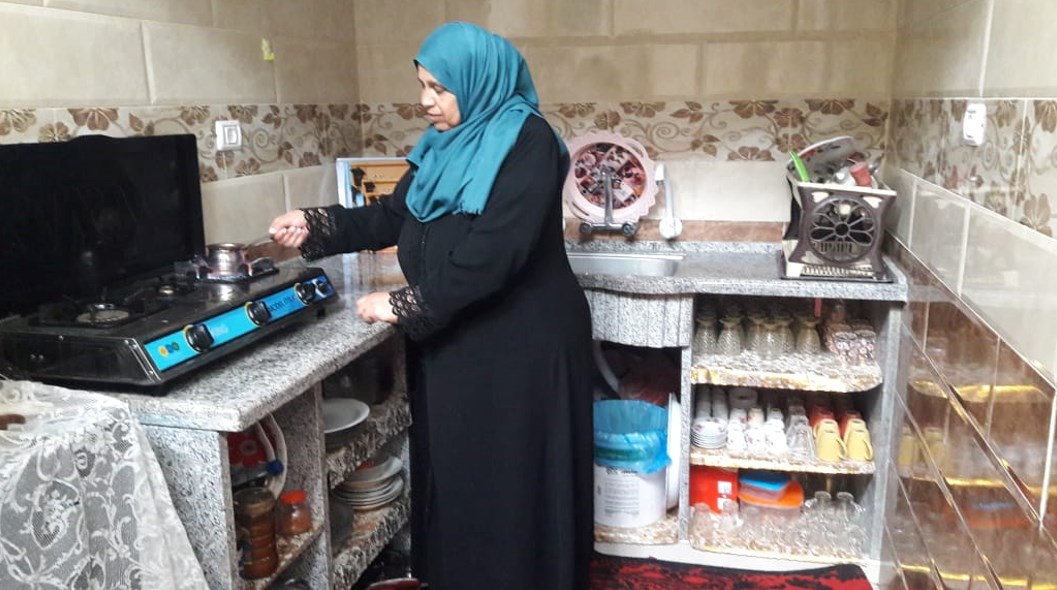 Ibtisam preparing coffee in her new kitchen