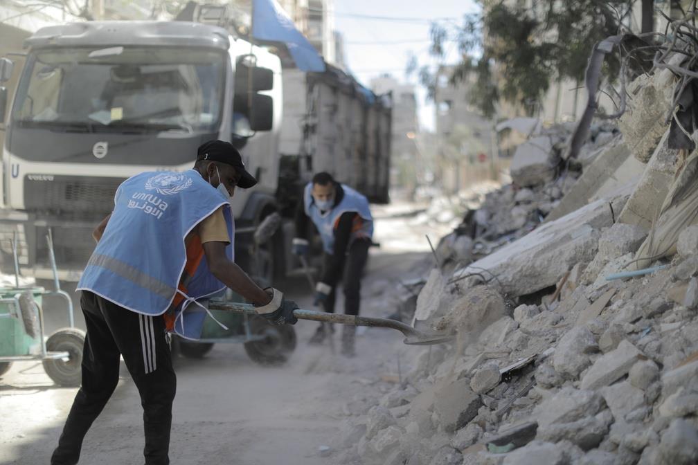 UNRWA sanitation workers clearing rubble, June 2021 © By Mohamed Hinnawi /UNRWA