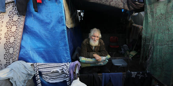 The approximately 111,500 older people in Gaza are among those most at risk of hunger, dehydration, illness, injury, and death, HelpAge reports. A displaced older Palestinian in a makeshift shelter. Photo by UNRWA