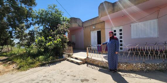 Umm Saleh Shreteh standing in front of her house in Al Mazra’a Al Qibliya, the central West Bank. Photo by OCHA