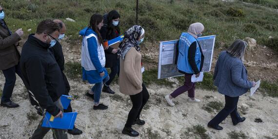 OCHA staff and others walking near the Palestinian villages of Yasuf and Madana, the West Bank, April 2021.