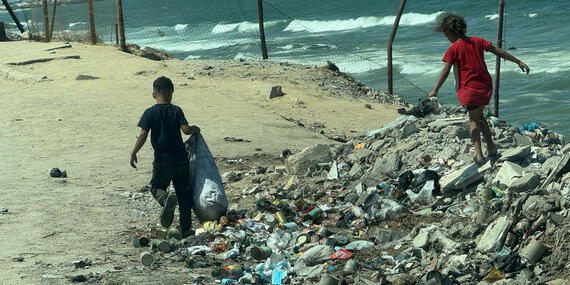 Children scavenging on Gaza’s shore. Photo by OCHA/Olga Cherevko