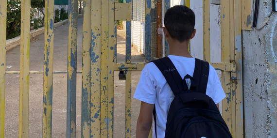 The son of Saadat Gharib standing in front of a gate installed by the Israeli military. The gate controls access to his family’s home, now encircled by settlement infrastructure. Photo by Shafea Jalamneh / Médecins du Monde Spain, Beit Ijza, East Jerusalem.