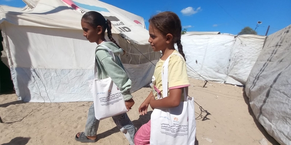 Displaced girls in southern Gaza walking from a temporary learning space they attend in Khan Younis, through funding by the occupied Palestinian territory Humanitarian Fund. Photo by War Child Holland 