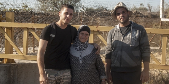 Hiyam Ahmad Jumaa, and her two sons in front of “Barrier Gate 105”, outside of Beit Surik village (Ramallah), 31 October, 2019. ©  Photo by OCHA