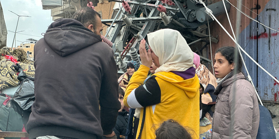 أشخاص يقفون في منطقة حضرية مدمرة في خانيونس خلال موجة أخرى من التهجير نحو رفح عقب تواصل احتدام الأعمال القتالية وأوامر الإخلاء الجديدة للمناطق السكنية الكبيرة. تصوير مكتب الأمم المتحدة لتنسيق الشؤون الإنسانية/أولغا تشيريفكو، 29 كانون الثاني/يناير 2024