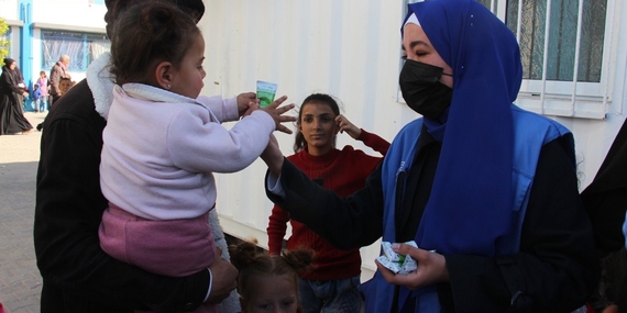 A humanitarian worker distributing vitamin supplies and nutrientsin Khan Younis. Photo by UNRWA