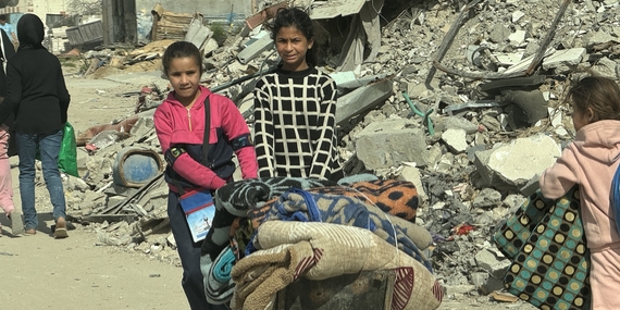 Girls carrying winter assistance items provided to them in Gaza city, 13 March 2025. Photo by OCHA/Olga Cherevko
