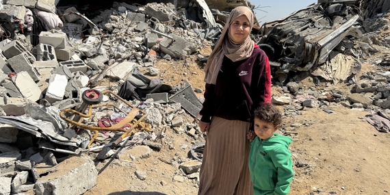 Yasmeen and her son stand amid the rubble of their destroyed home in Gaza, where renewed airstrikes and aid restrictions have deepened the humanitarian crisis. Photo: OCHA/Olga Cherevko