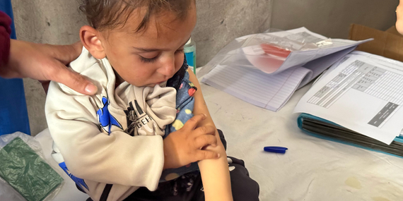 A child being screened for malnutrition in Khan Younis, 15 April 2025. Photo by OCHA/Olga Cherevko