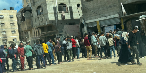 Palestinians queueing for food assistance in front of a distribution point in Khan Younis. Photo: OCHA/Olga Cherevko