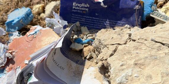 Damaged study book found on the ground after the demolition of a school in Ein Samiya, West Bank.