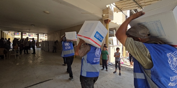 UNRWA Team providing assistance to displaced families in Al- Tabi’een school in Gaza city. Photo: UNRWA