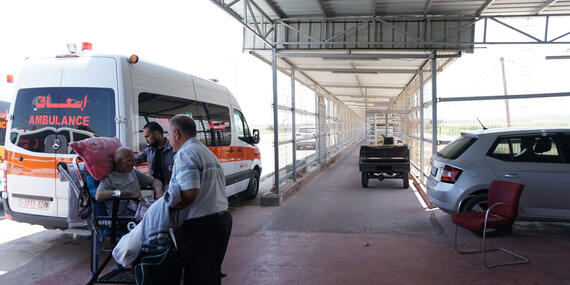 Old man with a cancer patient exiting to Istishari Arab Hospital at Ramallah to receive medical treatment.