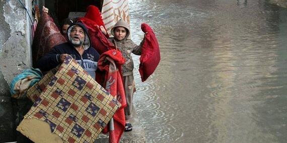 Family evacuating their home in Gaza, 12 December 2013 Family evacuating their home in Gaza, 12 December 2013