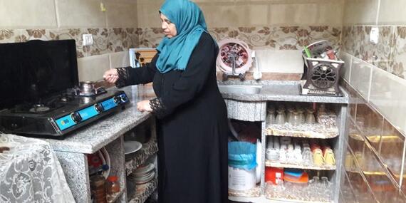 Ibtisam preparing coffee in her new kitchen