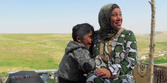 Shifaa Abu Iram and her son sitting in Halaweh community, Massafer Yatta (Firing zone 918).  © Photo by OCHA