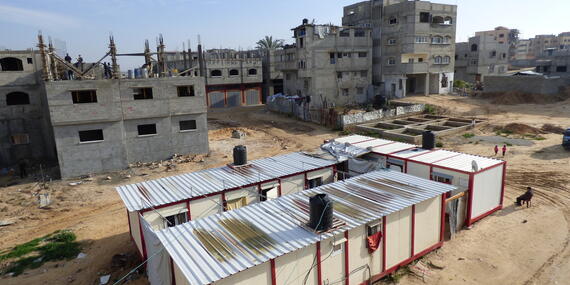 Caravans provided to displaced families and buildings under reconstruction in Shuja’iyeh neighbourhood, Gaza city, January 2016. © Photo by OCHA