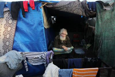 The approximately 111,500 older people in Gaza are among those most at risk of hunger, dehydration, illness, injury, and death, HelpAge reports. A displaced older Palestinian in a makeshift shelter. Photo by UNRWA