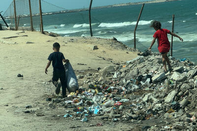 Children scavenging on Gaza’s shore. Photo by OCHA/Olga Cherevko