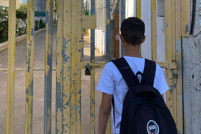 The son of Saadat Gharib standing in front of a gate installed by the Israeli military. The gate controls access to his family’s home, now encircled by settlement infrastructure. Photo by Shafea Jalamneh / Médecins du Monde Spain, Beit Ijza, East Jerusalem.