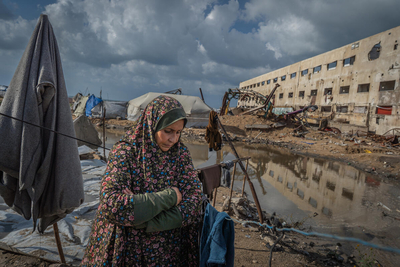 Najat stands outside of her tent in Gaza city, which was flooded after a sewage system nearby overflooded due to heavy rain. Photo by WFP/Maxime Le Lijour 
