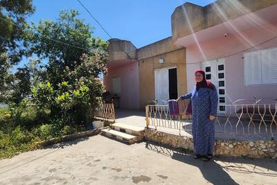 Umm Saleh Shreteh standing in front of her house in Al Mazra’a Al Qibliya, the central West Bank. Photo by OCHA