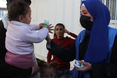A humanitarian worker distributing vitamin supplies and nutrientsin Khan Younis. Photo by UNRWA