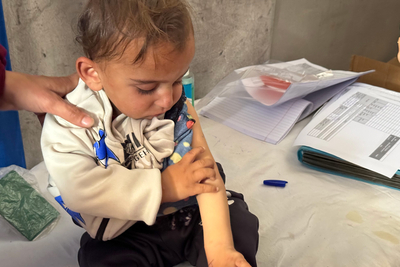 A child being screened for malnutrition in Khan Younis, 15 April 2025. Photo by OCHA/Olga Cherevko
