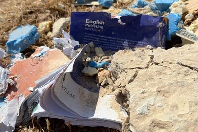 Damaged study book found on the ground after the demolition of a school in Ein Samiya, West Bank.