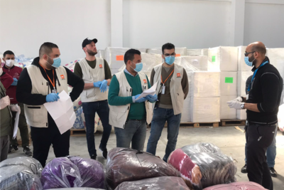 Staff of an aid organization preparing for the distribution of bedding sets to isolation centers. April 2020, Rafah. Photo by NRC