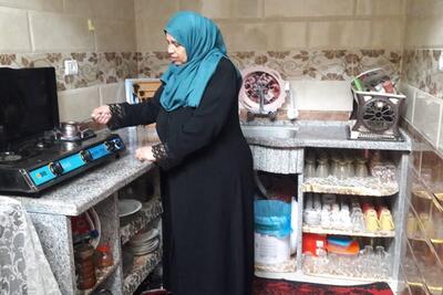 Ibtisam preparing coffee in her new kitchen