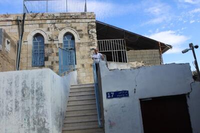 Mr. Salah in front of his family home from which he was evicted. Photo by OCHA