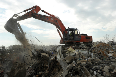 Palestinian workers removing debris from the Shuja'iyeh neighbourhood in Gaza as part of UNDP’s USD 13.7 million rubble removal programme. The programme is funded by Sweden, Japan and USA. Photo by UNDP/PAPP