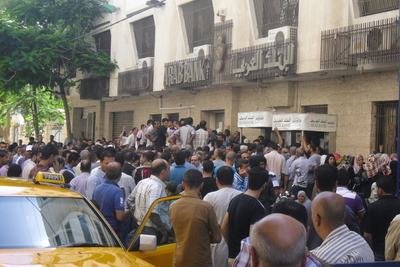 People queuing at the ATM at the Arab Bank. Rimal area, Gaza. December 2014. Photo by OCHA