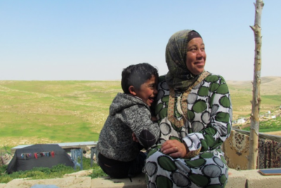 Shifaa Abu Iram and her son sitting in Halaweh community, Massafer Yatta (Firing zone 918).  © Photo by OCHA