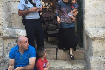 Settler family leaving Palestinian evicted property in East Jerualsem, shortly after taking it over on 15 September 2016. Photo by OCHA